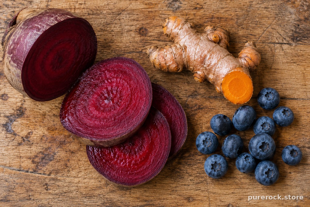 Sliced beetroot, fresh turmeric root and blueberries on a wooden board, showing natural fruit and vegetable sources of colouring